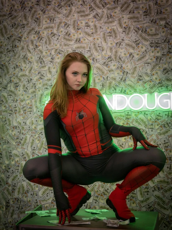 a woman dressed in a spiderman costume poses for a pograph