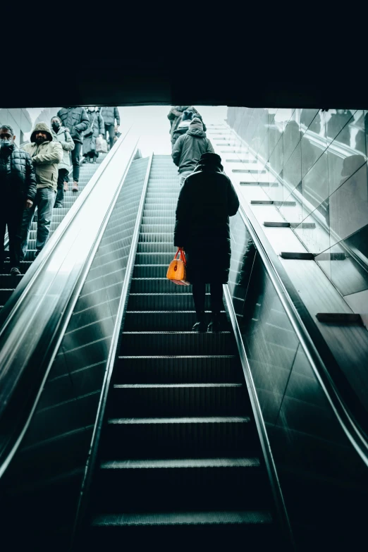 a woman that is walking down some stairs with luggage