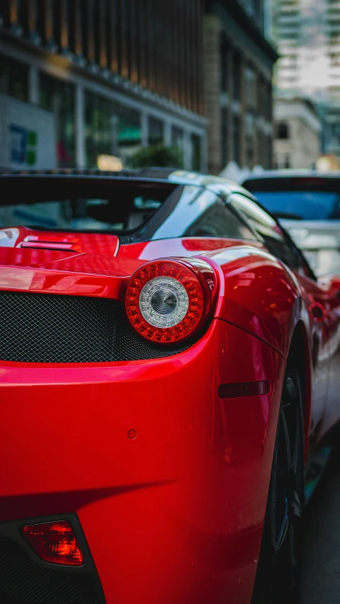 a red sports car is parked on the street