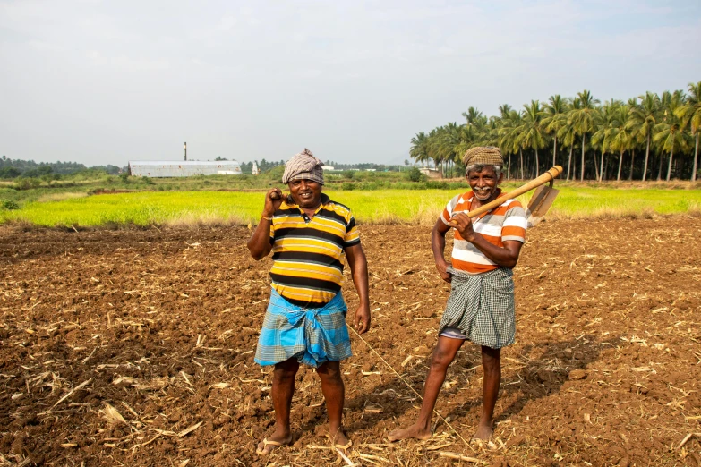 two men who are standing in the dirt