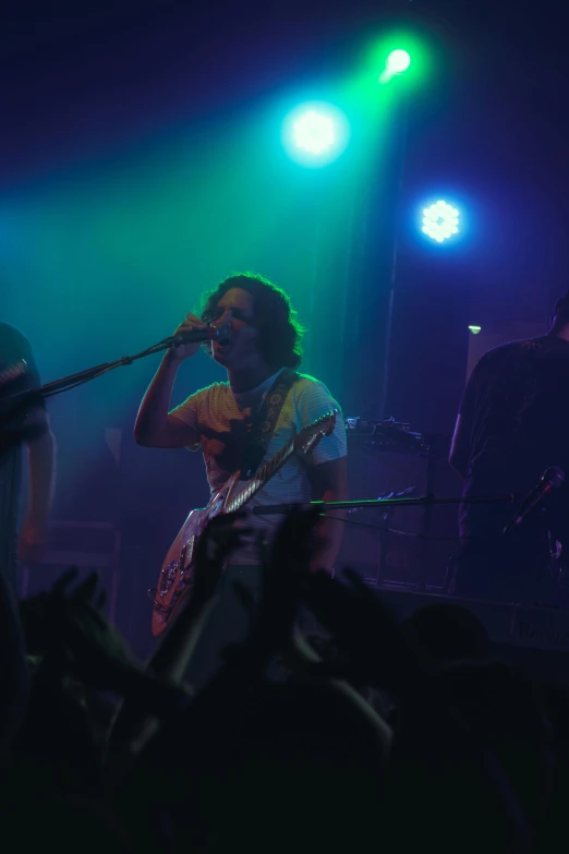 a man that is standing on a stage with a microphone