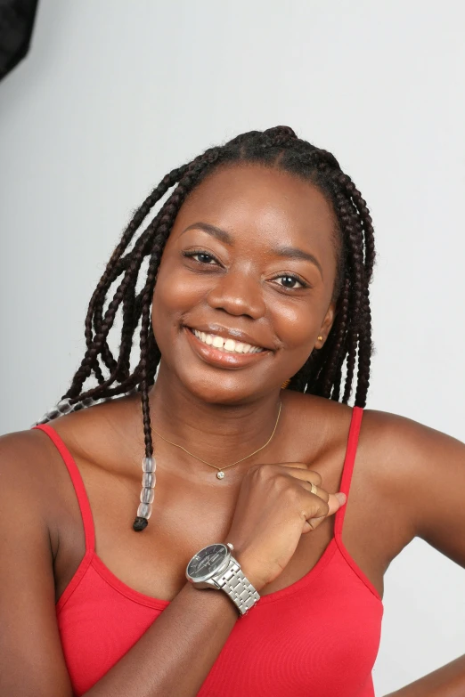 a woman in a red top smiles at the camera