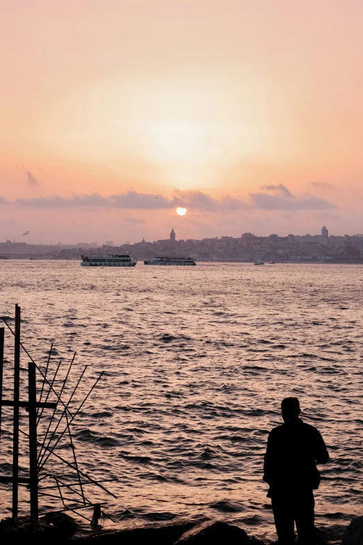 a person is watching boats on the water