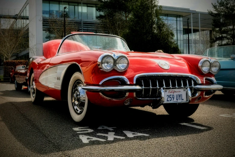 a vintage red car in a parking lot