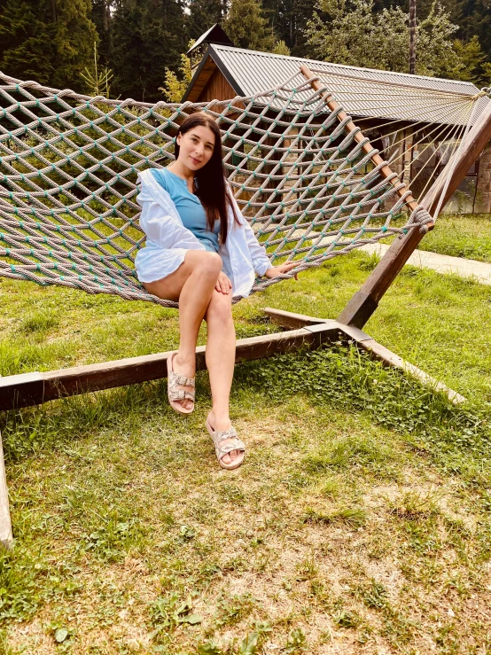 a girl posing for a po in a hammock