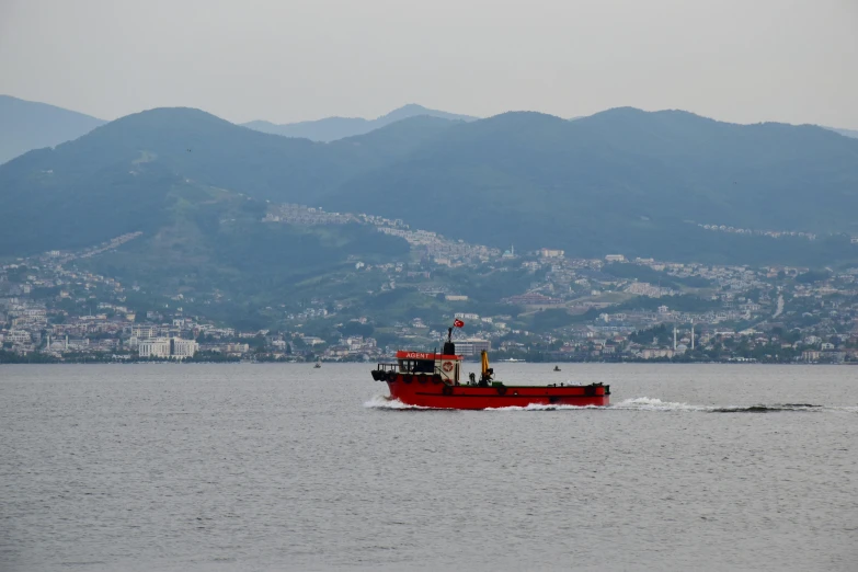 a red and white tug boat is in the water