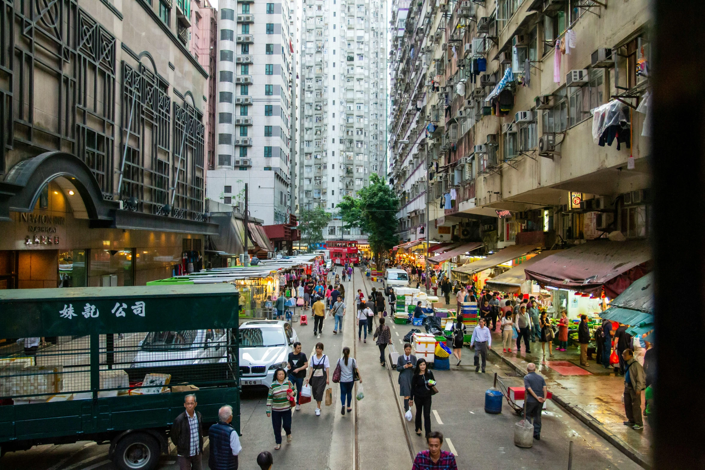 many people walking around an urban street market