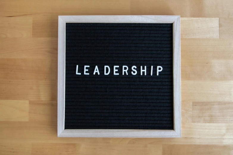 a close up view of a black board with the word leadership