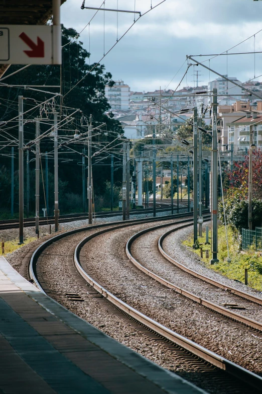 a set of train tracks with buildings in the background