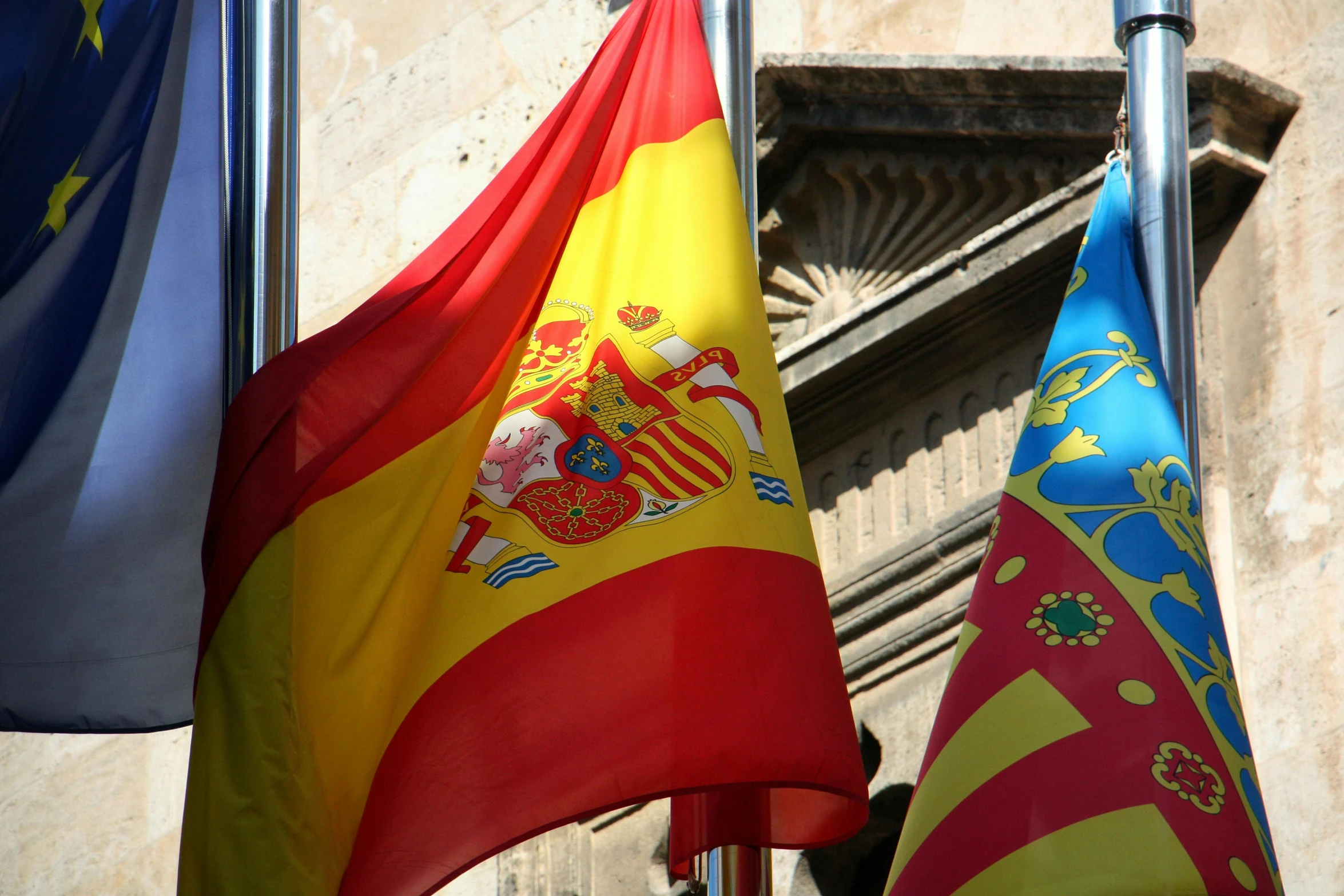 many flags are hanging on the wall of the building