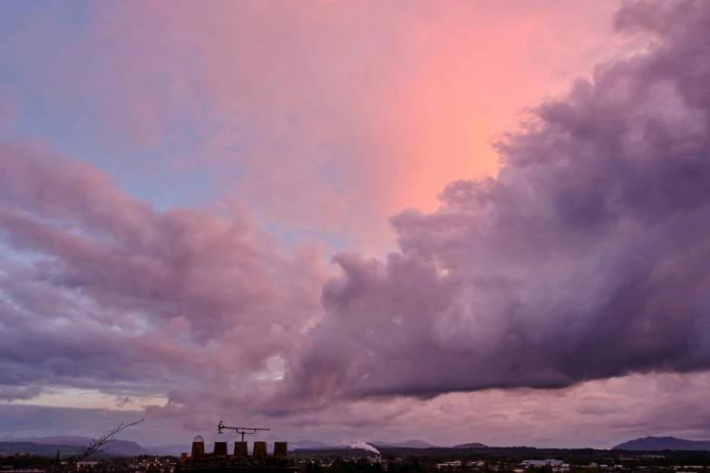 several buildings are shown under an orange cloudy sky