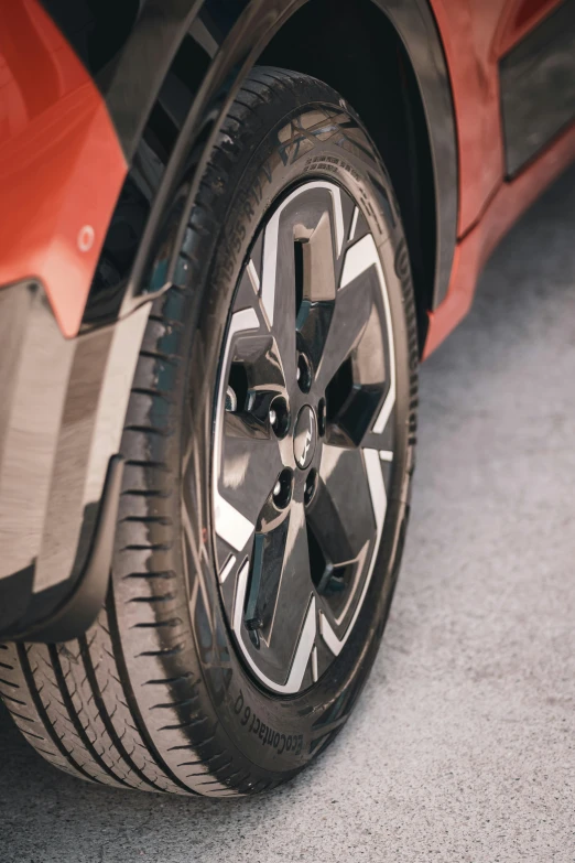 the rear wheel of an orange sport car