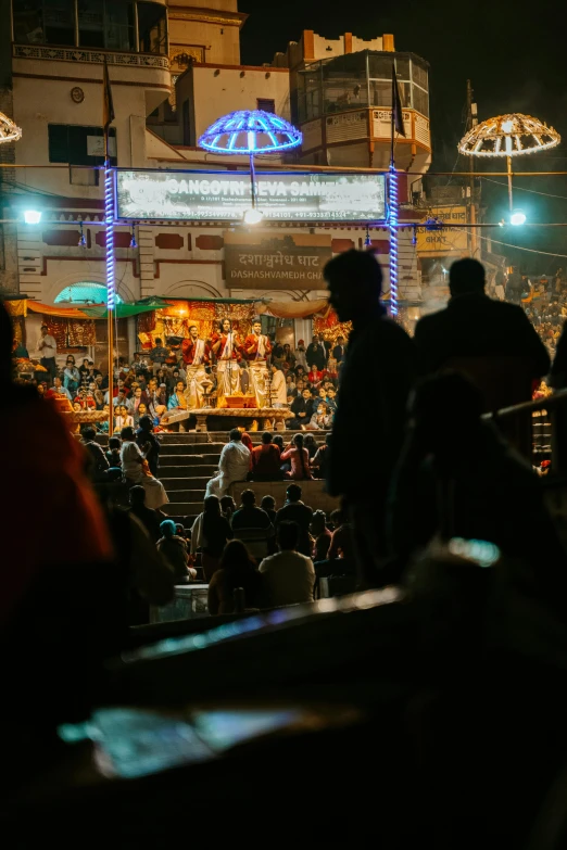 large crowd gathered in front of lit up shrine