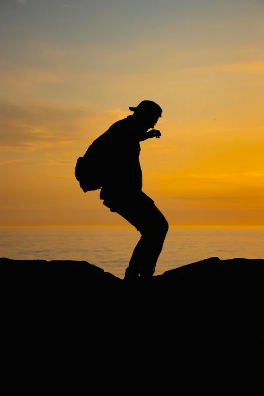 a man standing on a hill near a lake