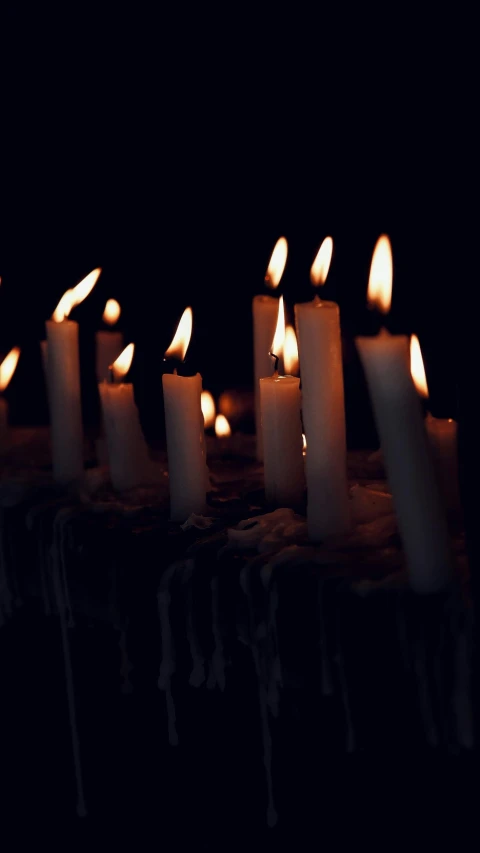 candles lit up on a table in the dark