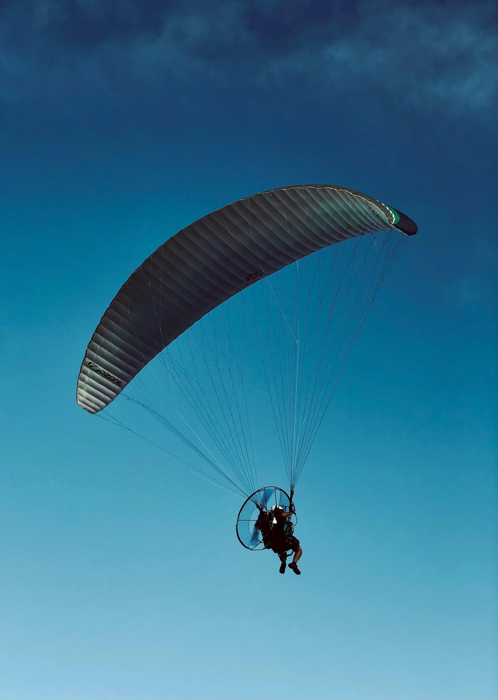 a person in the air with a parachute