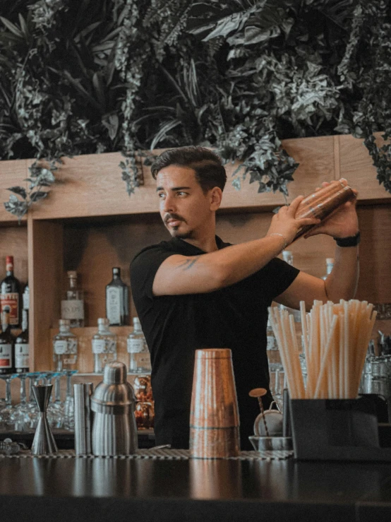 a man preparing a drink at the bar