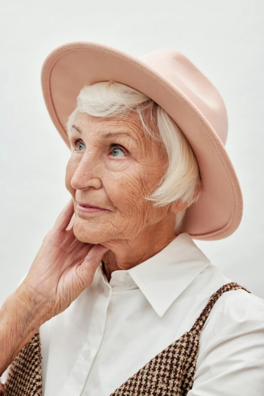 a very older lady wearing a pink hat