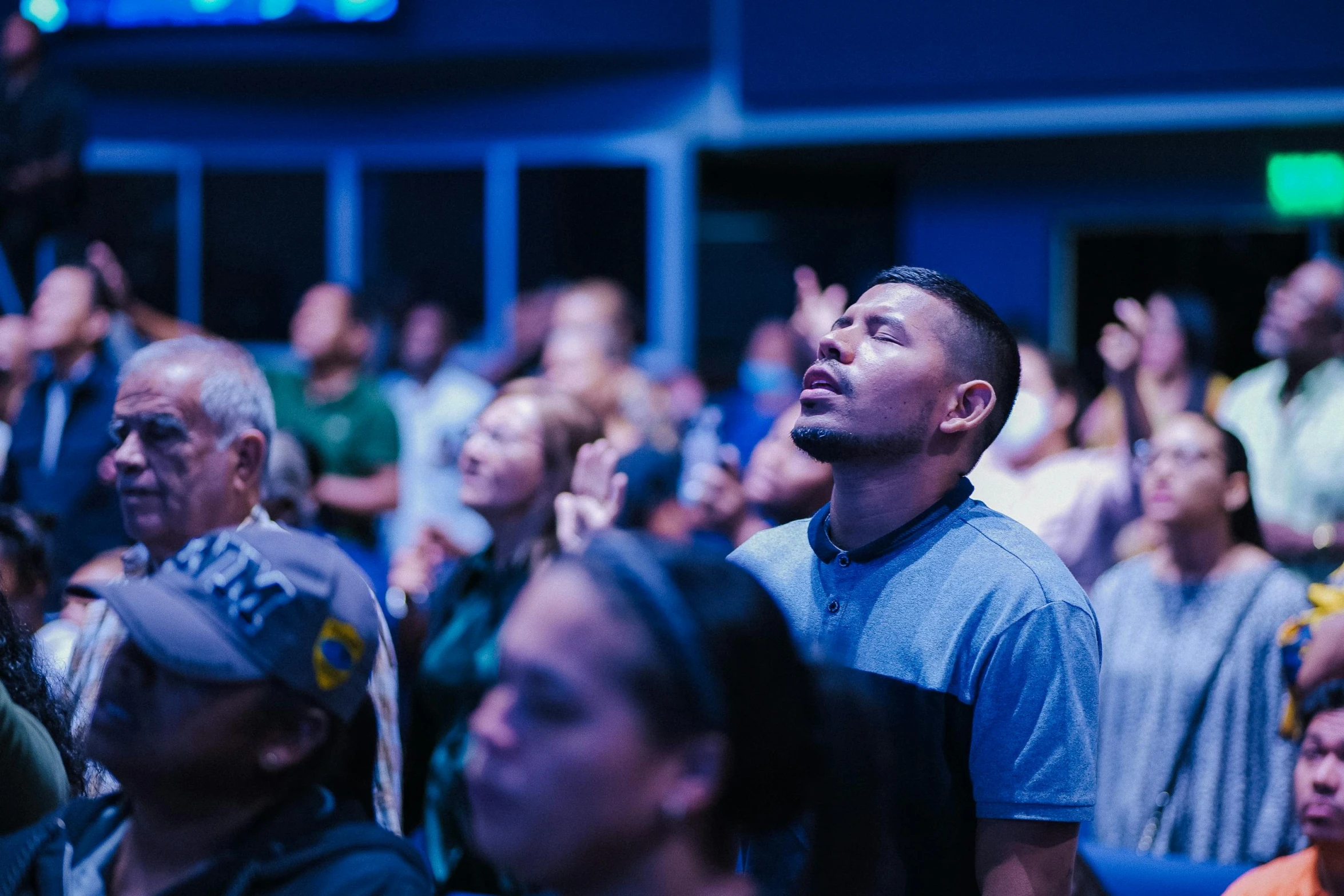 an audience in the auditorium applauds their speakers