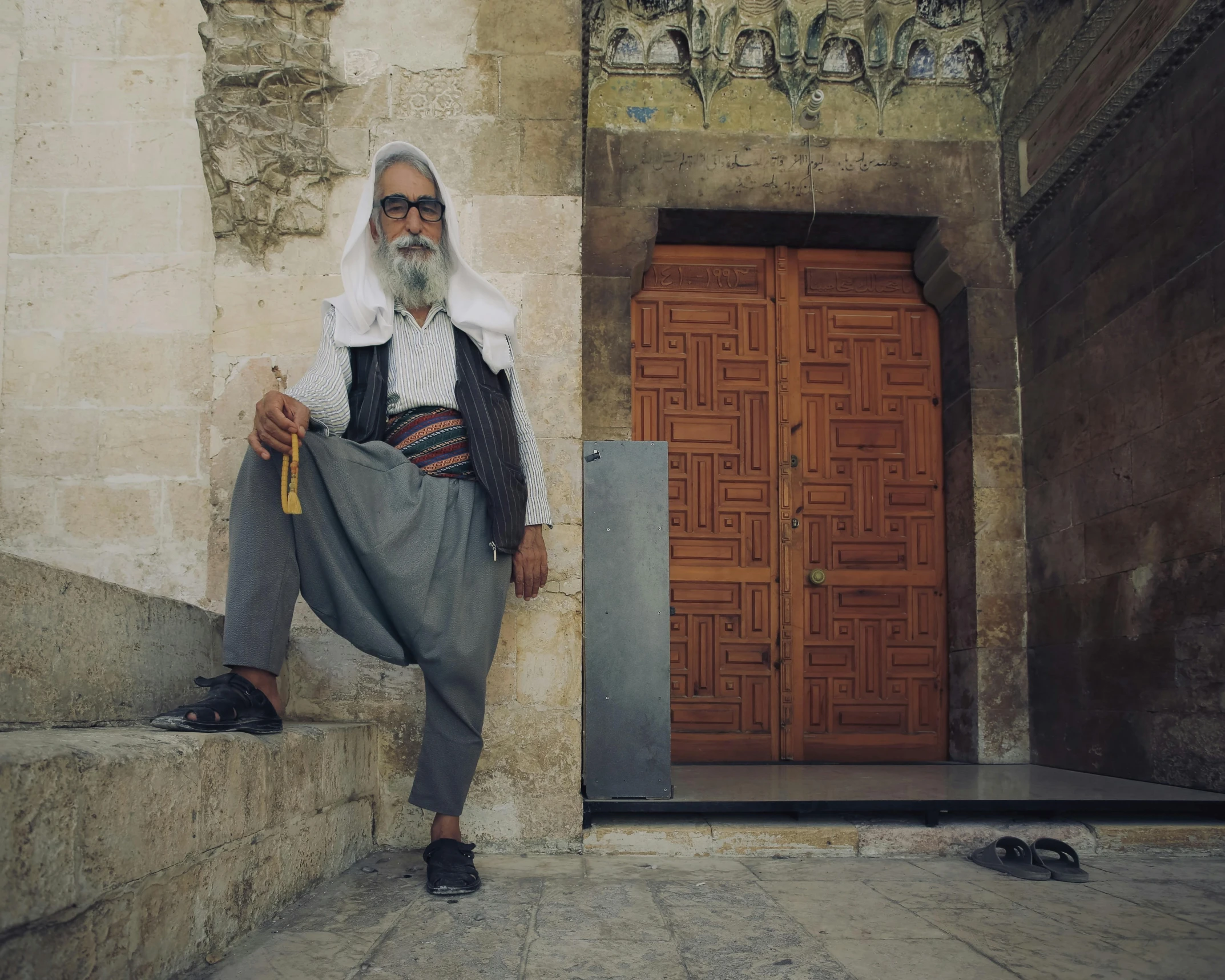 man with turban and black shirt posing for a po