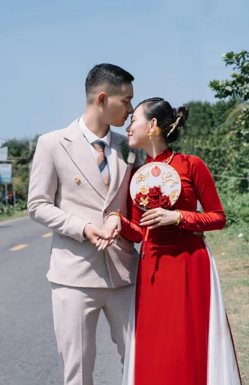 young couple dressed in wedding garb looking into each others eyes