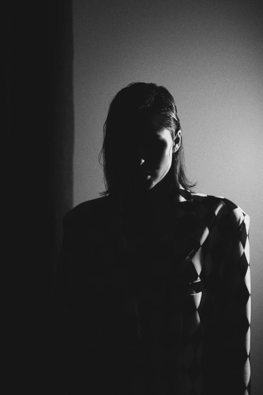 a woman in the dark is seen in silhouette