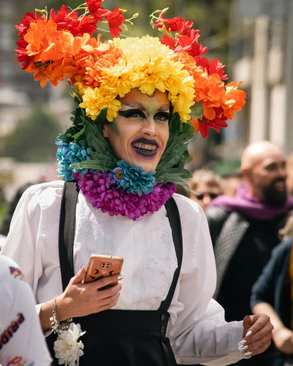 a person with flower hats using a cell phone