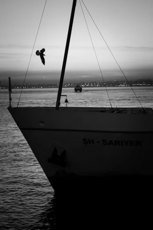 an old boat in the water during a sunset