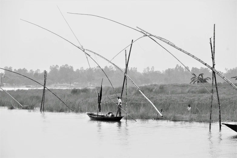 a person fishing in a boat with poles