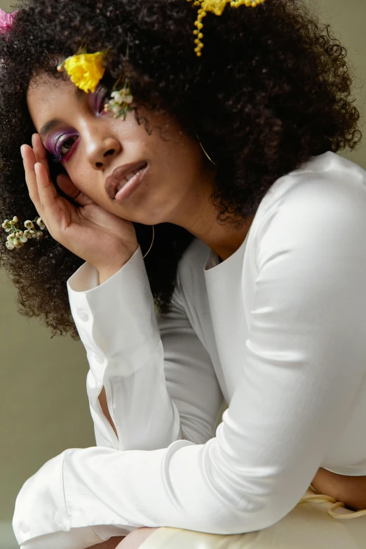 an african american woman in white shirt sitting