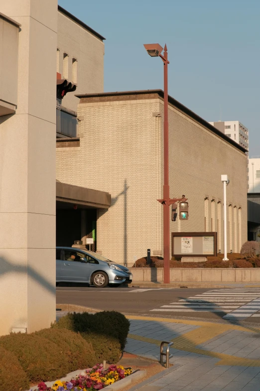 a gray car parked in front of an old building