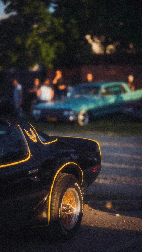 an old model muscle car parked on a parking lot