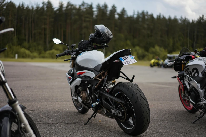 two motorcyclists are parked side by side