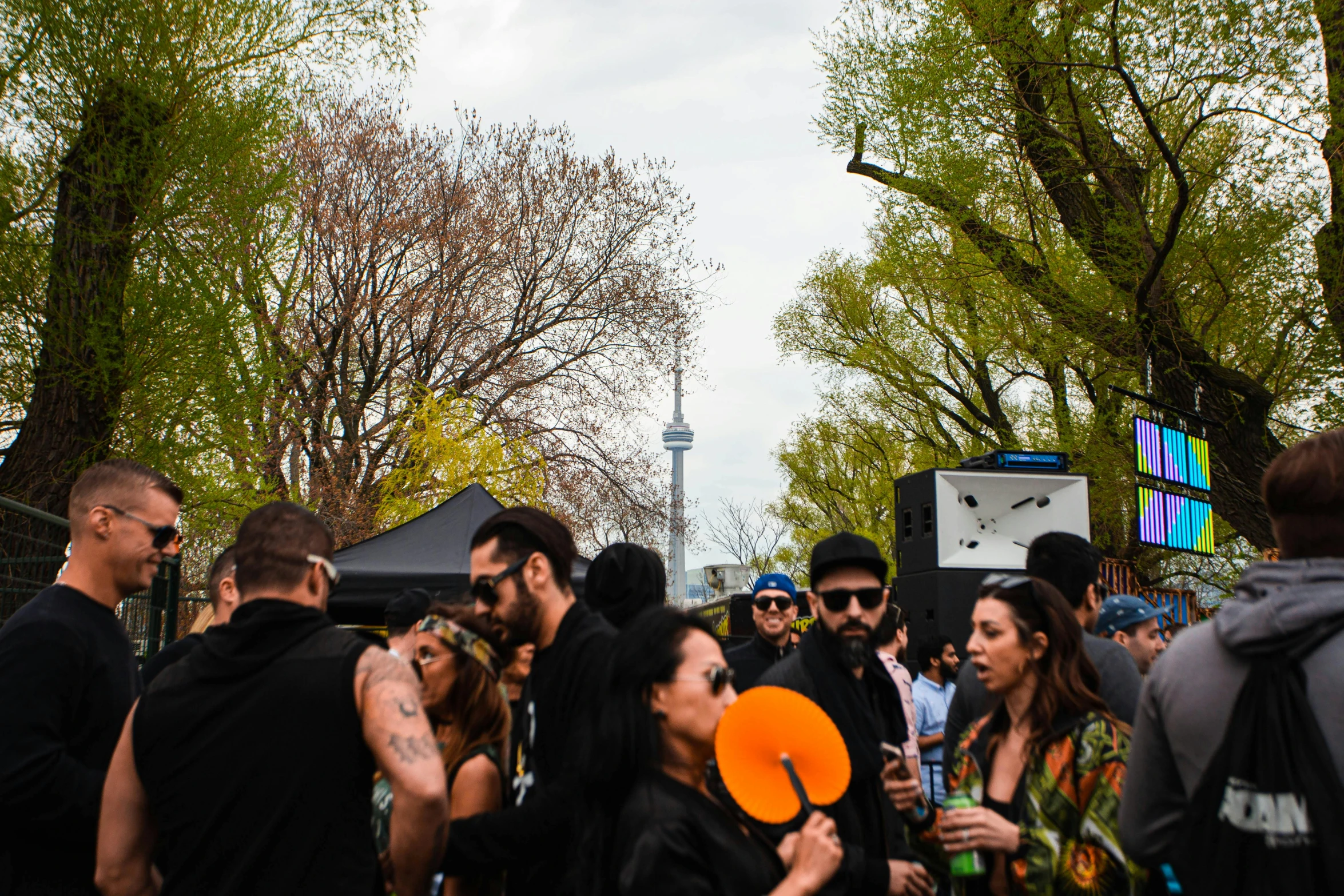 people standing around on a street with orange frisbees