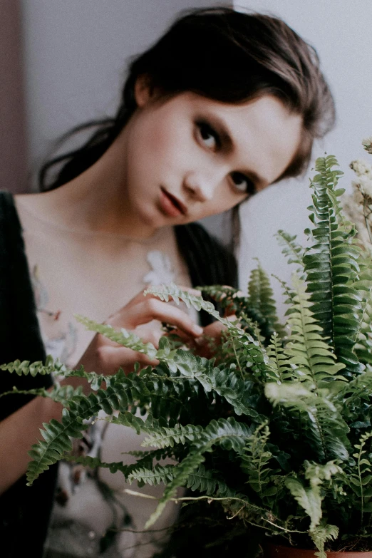 a woman looks at flowers in front of her