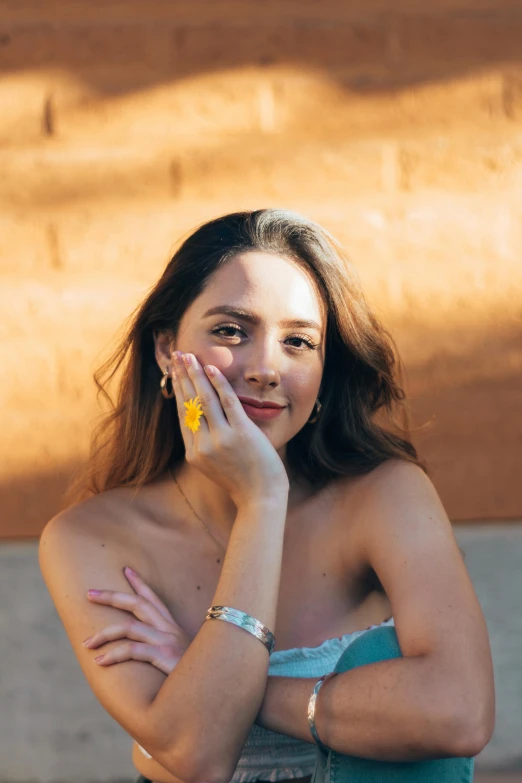 a woman smiles as she poses for a picture