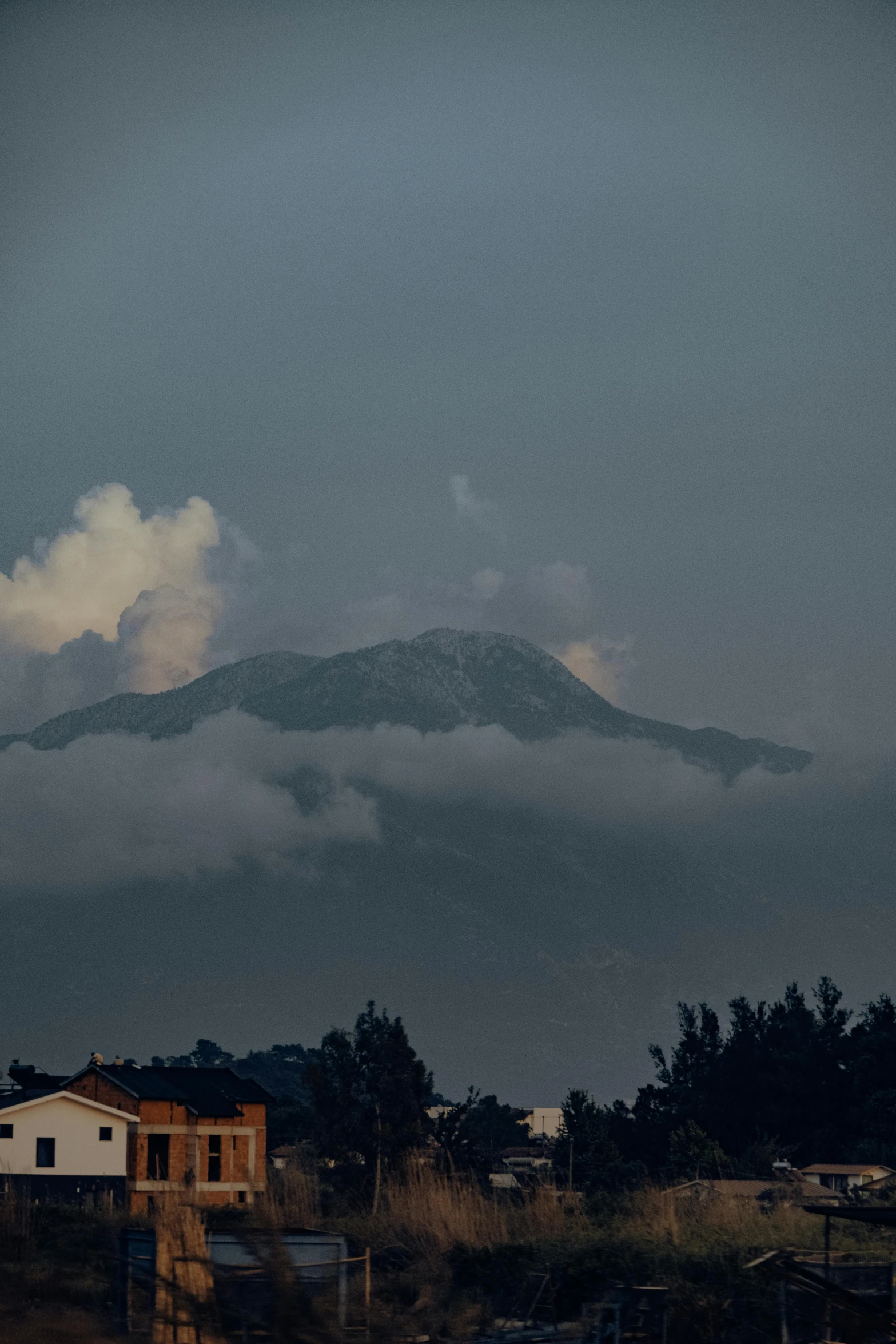 the top of a mountain is seen in a small town