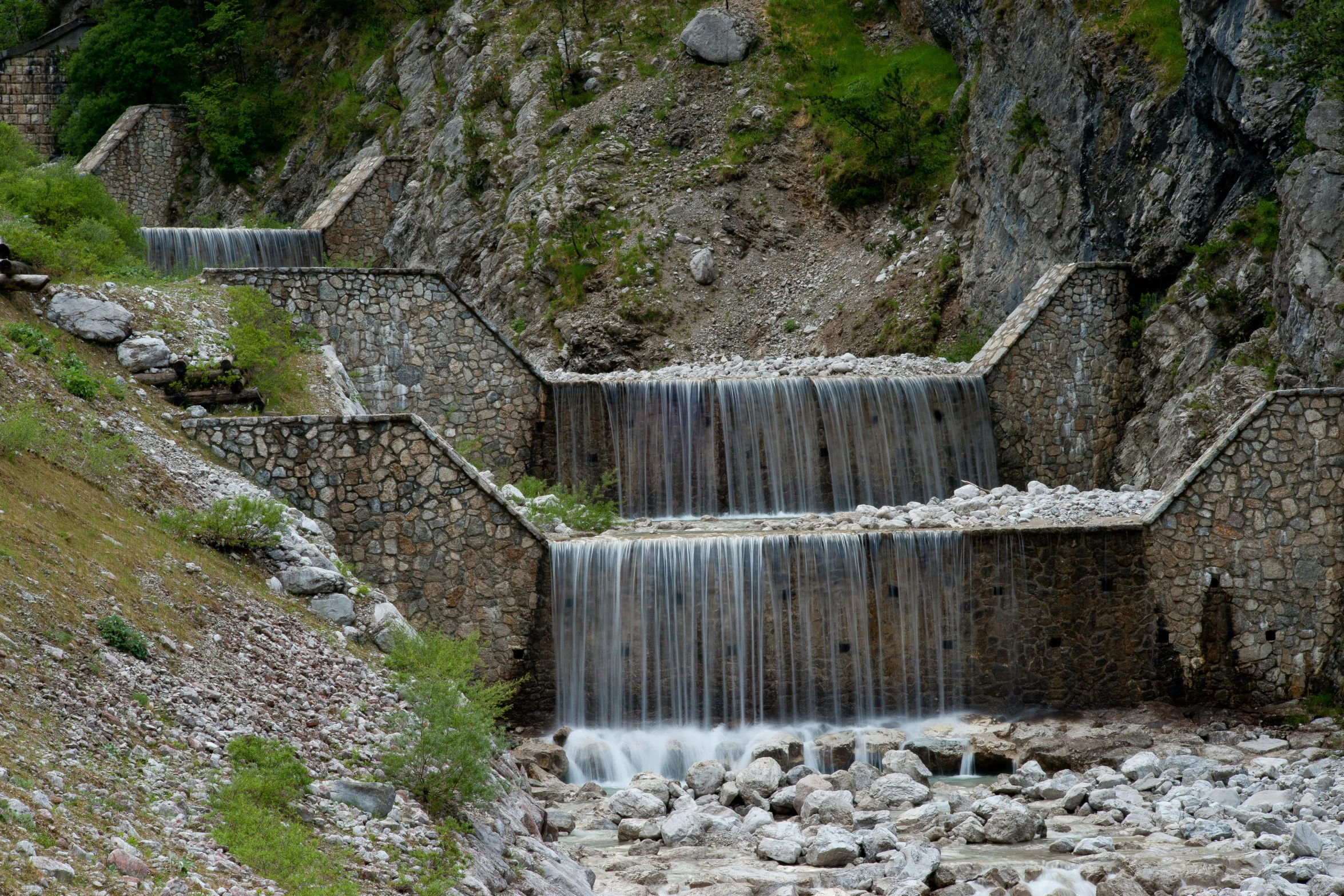 this is a small waterfall coming down the side of a hill