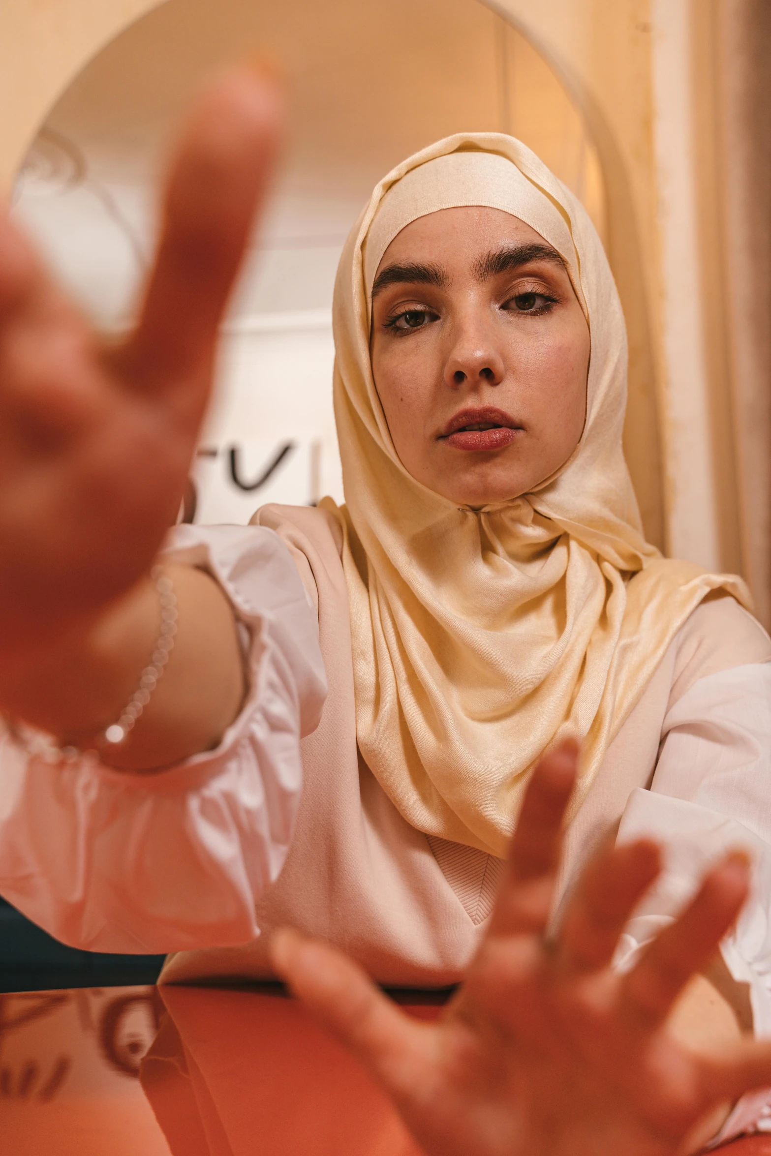 a woman giving the sign in front of her face