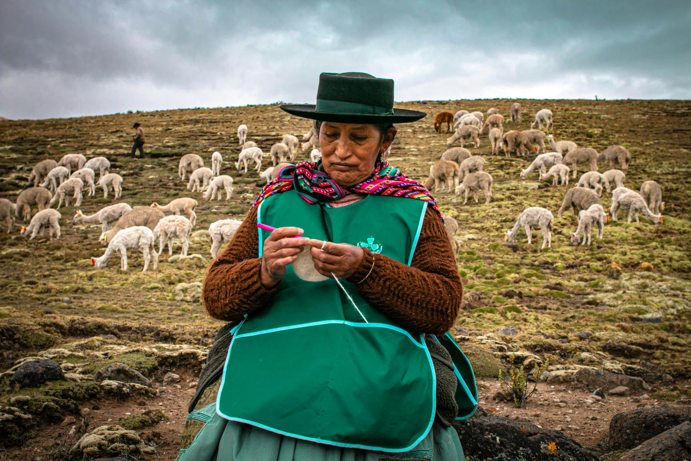 a woman in an apron and hat is standing with a herd of sheep