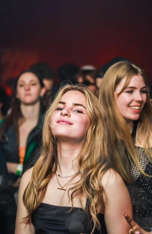 three beautiful women looking up in front of their spectators