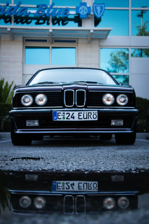 a black car is parked in front of a building