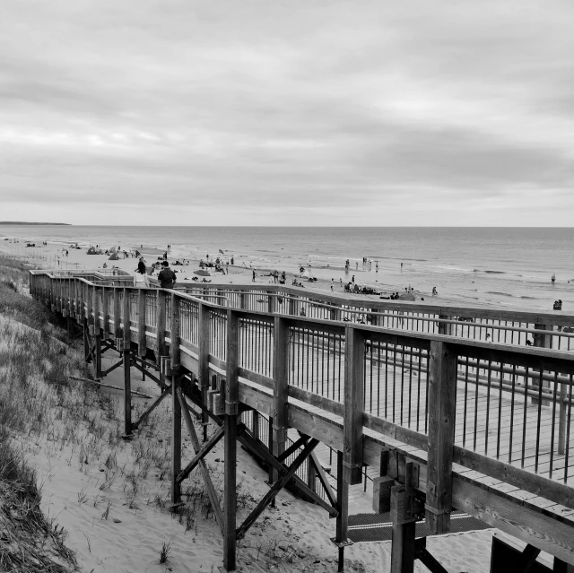 people walking on the beach along side the water