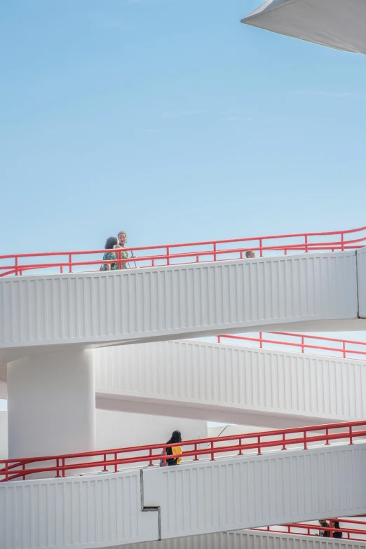 a group of people are standing on the railings