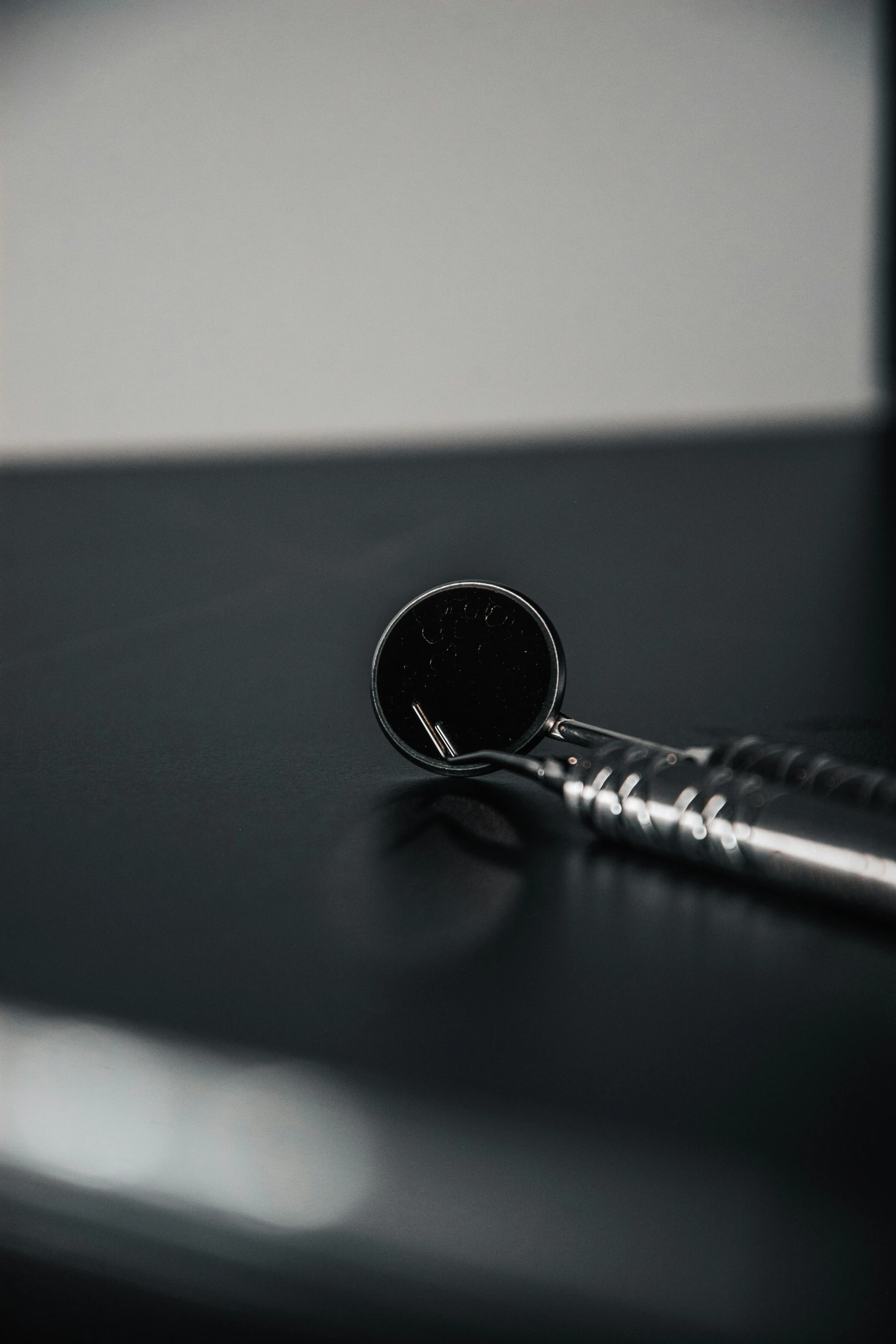 a round black glass sitting on top of a metal table