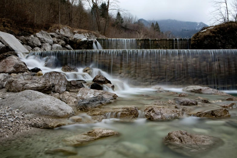 the water in the stream has clear rocks