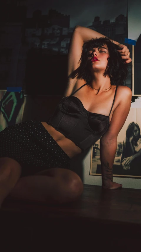 a woman laying down on top of a wooden table