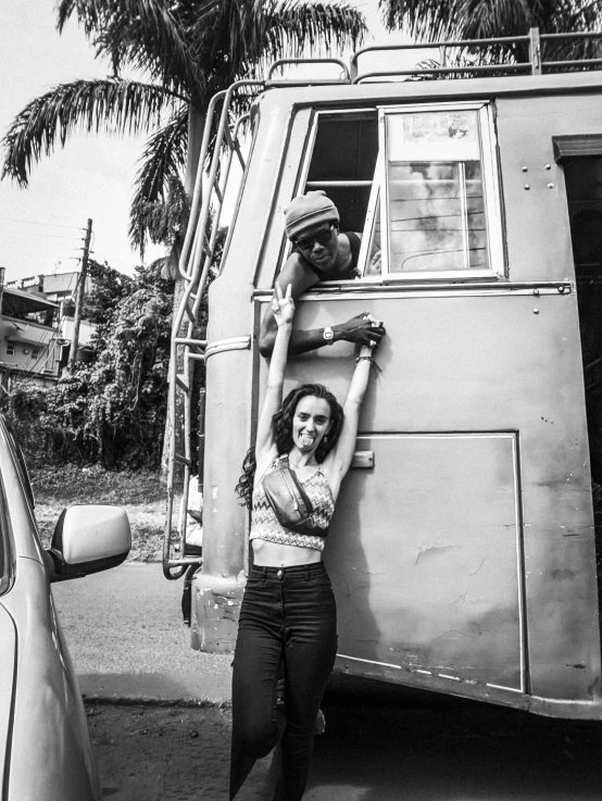 a woman is holding onto an open door van