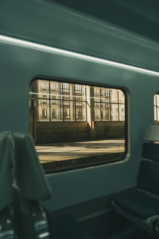 a window with a train car on it and light shining in