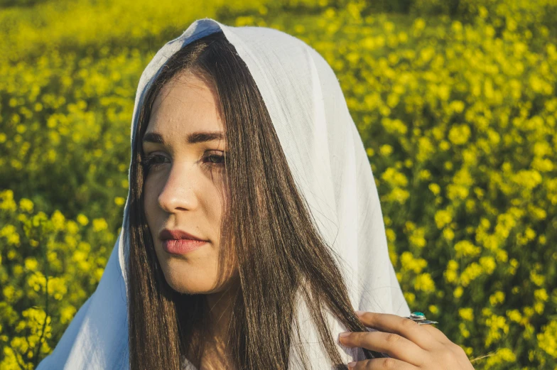 a girl is standing in the middle of yellow flowers